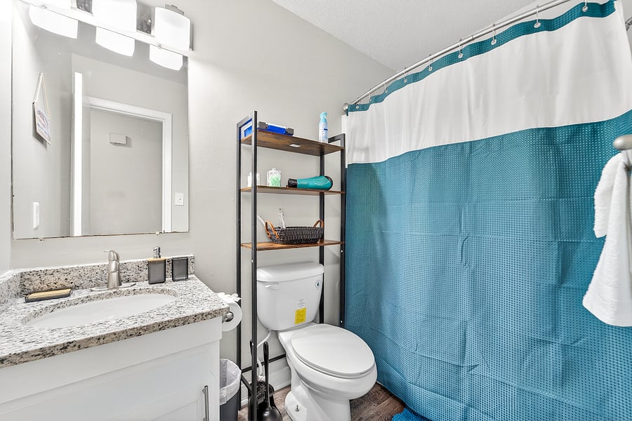 Bathroom with cleaning stuff, first aide kit and dryer