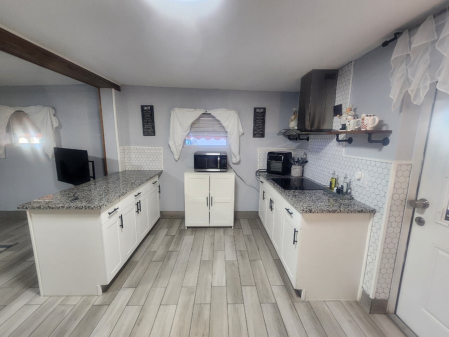 Kitchen cooking area. Full granite counter tops