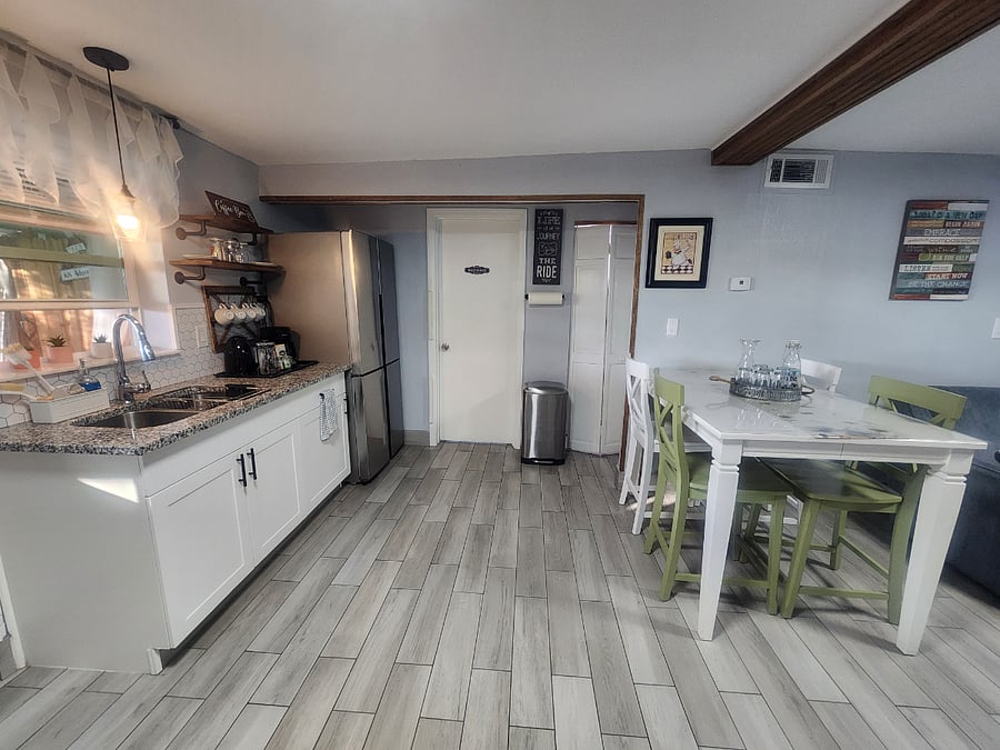 Kitchen and sink. full size fridge, dining area