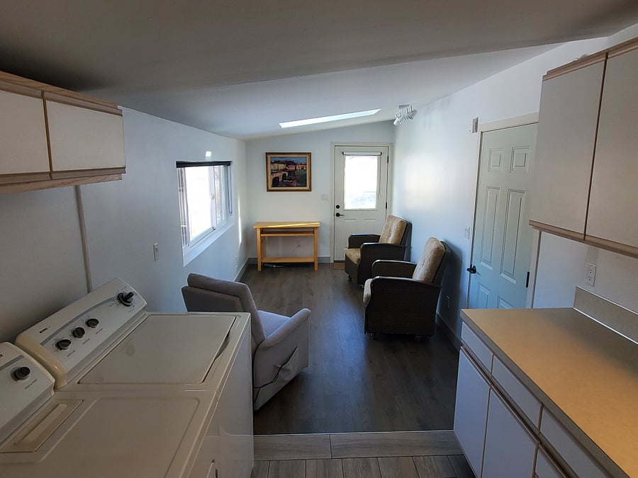 Looking towards the office from the kitchen washer dryer area. Door to garage is on the right.