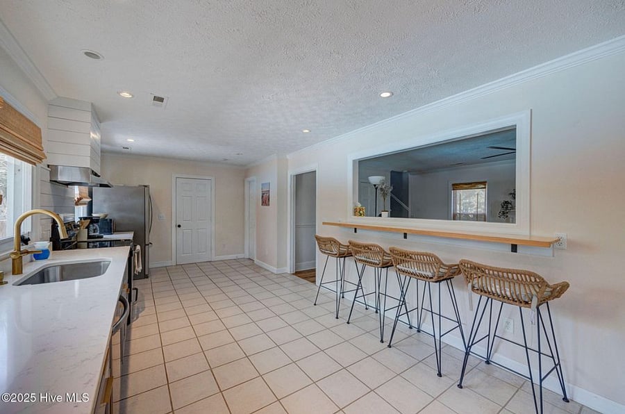 Open, fully equipped kitchen with modern appliances and plenty of counter space, seamlessly connected to the living area for easy cooking and gathering.