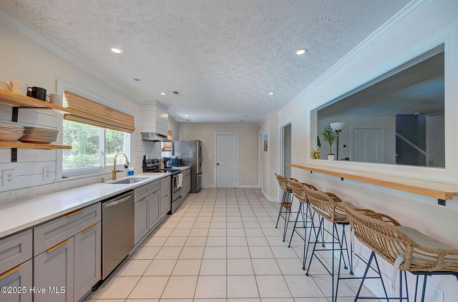 Open, fully equipped kitchen with modern appliances and plenty of counter space, seamlessly connected to the living area for easy cooking and gathering.