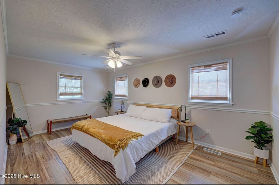 Spacious master bedroom with a comfortable bed and direct views of the pool, creating a serene retreat for rest and relaxation.