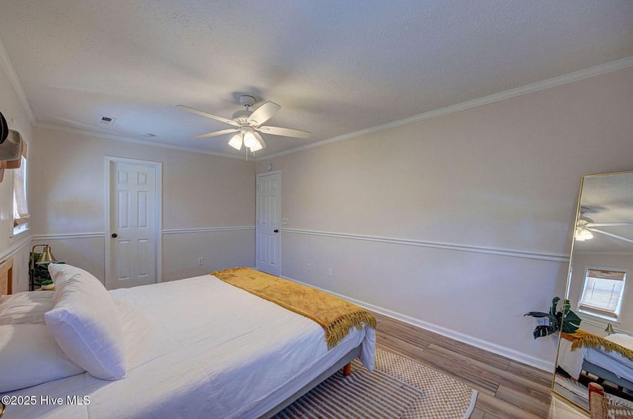 Spacious master bedroom with a comfortable bed and direct views of the pool, creating a serene retreat for rest and relaxation.