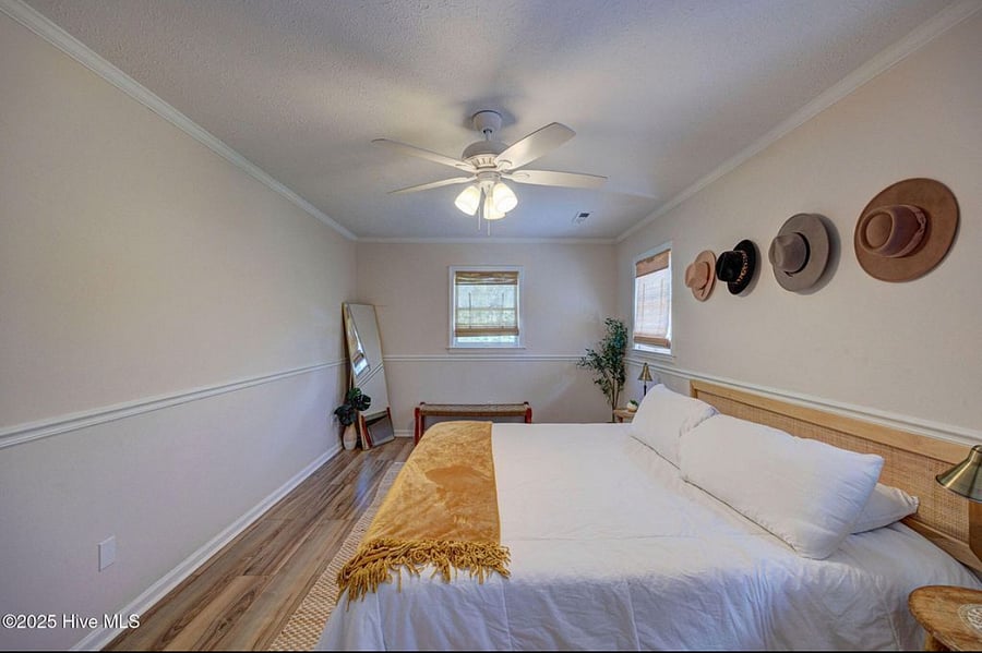 Spacious master bedroom with a comfortable bed and direct views of the pool, creating a serene retreat for rest and relaxation.