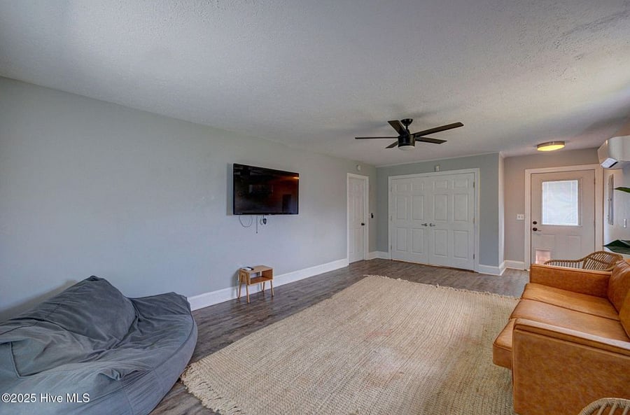 Spacious downstairs lounge with comfortable seating, large TV, and in-room washer and dryer. Just steps from a full bathroom and with direct access to the pool, its a versatile space to relax, entertain, or host extra guests.