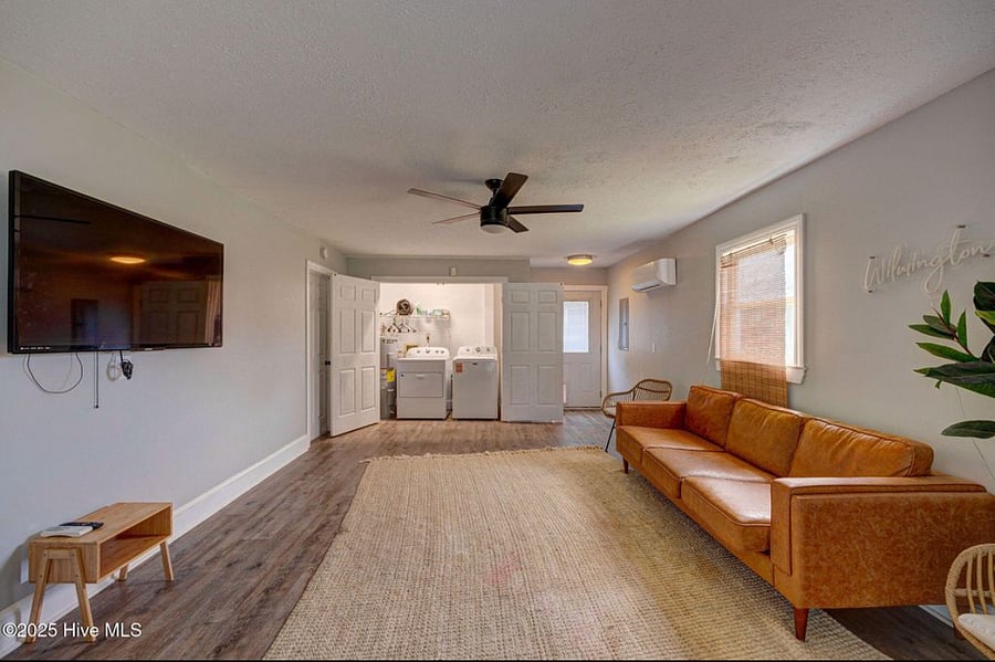 Spacious downstairs lounge with comfortable seating, large TV, and in-room washer and dryer. Just steps from a full bathroom and with direct access to the pool, its a versatile space to relax, entertain, or host extra guests.