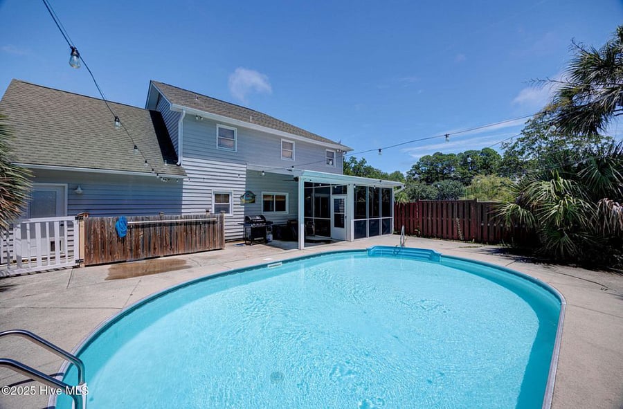 Private pool with lounge seating and a barbecue grill, ideal for relaxing, entertaining, or enjoying sunny coastal days.