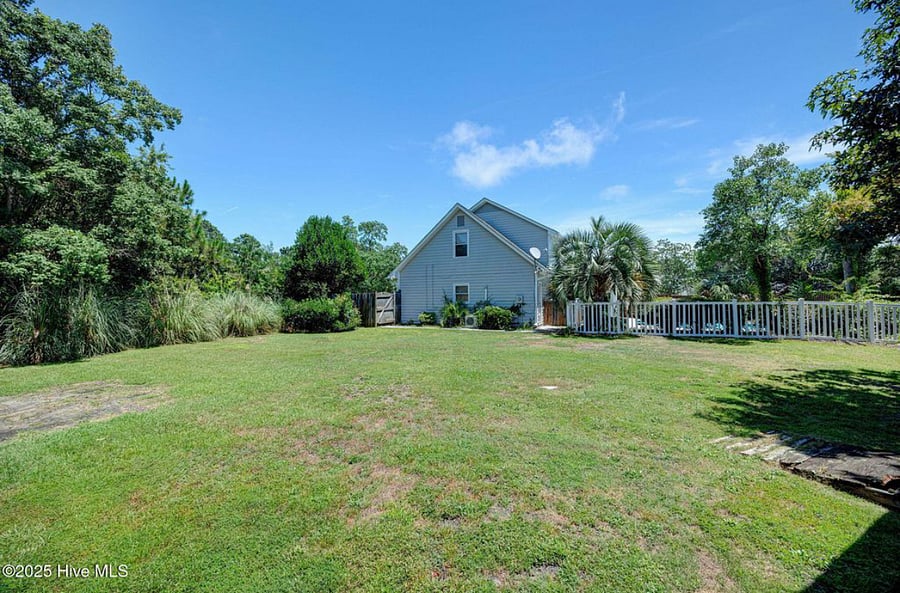 Large backyard with plenty of open space and a shed for storage a flexible area for outdoor activities, pets, or additional gatherings.