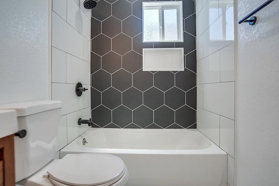 Full bathroom with shower / bath combo.
