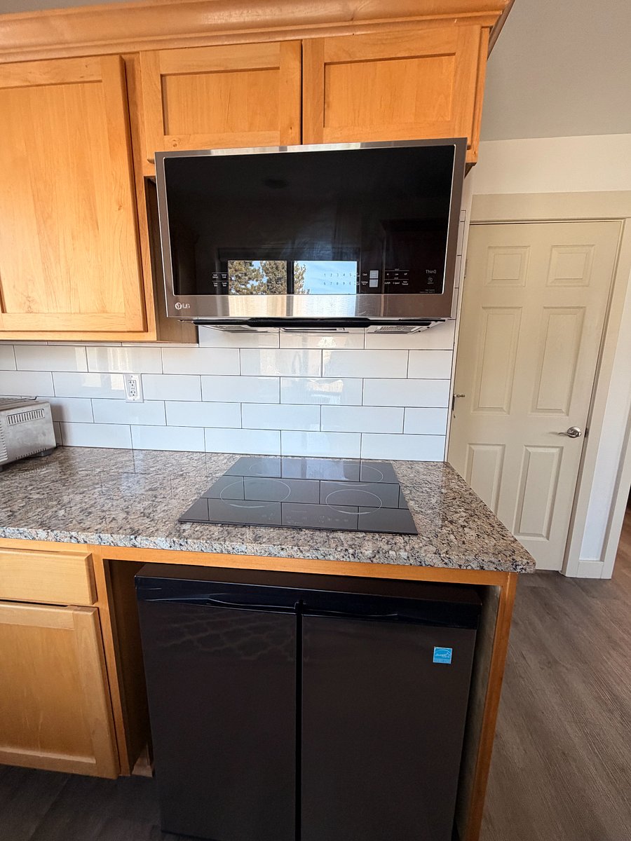 Microwave-convection oven combination/induction stovetop/under counter midsize refrigerator-freezer combo (access to second large refrigerator in garage)