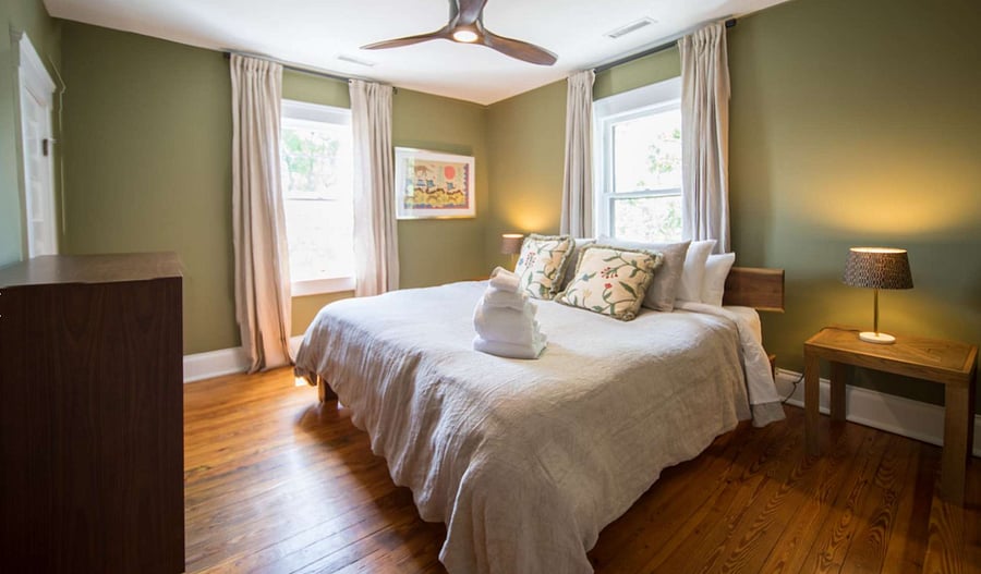 King Size Bedroom with closet, blackout curtains, and dresser.
