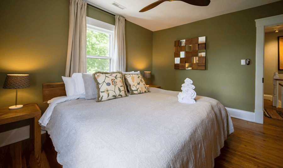 King Size Bedroom with closet, blackout curtains, and dresser.