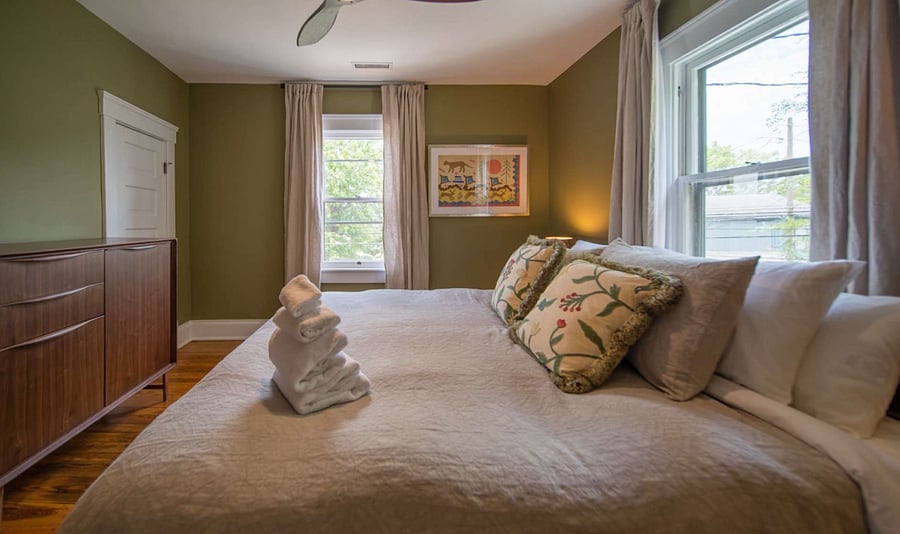 King Size Bedroom with closet, blackout curtains, and dresser.