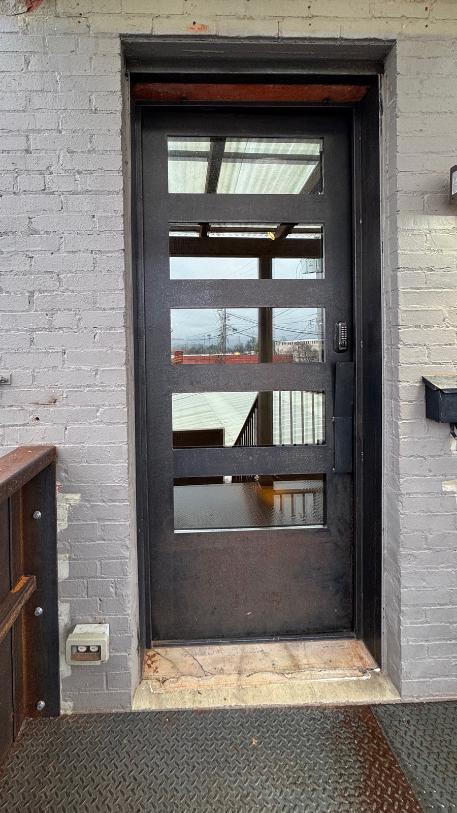 Private entrance at the top of steel stairs.