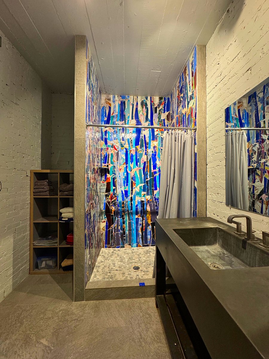 Shower in the bathroom, with hand-set mosaic floor to ceiling. 