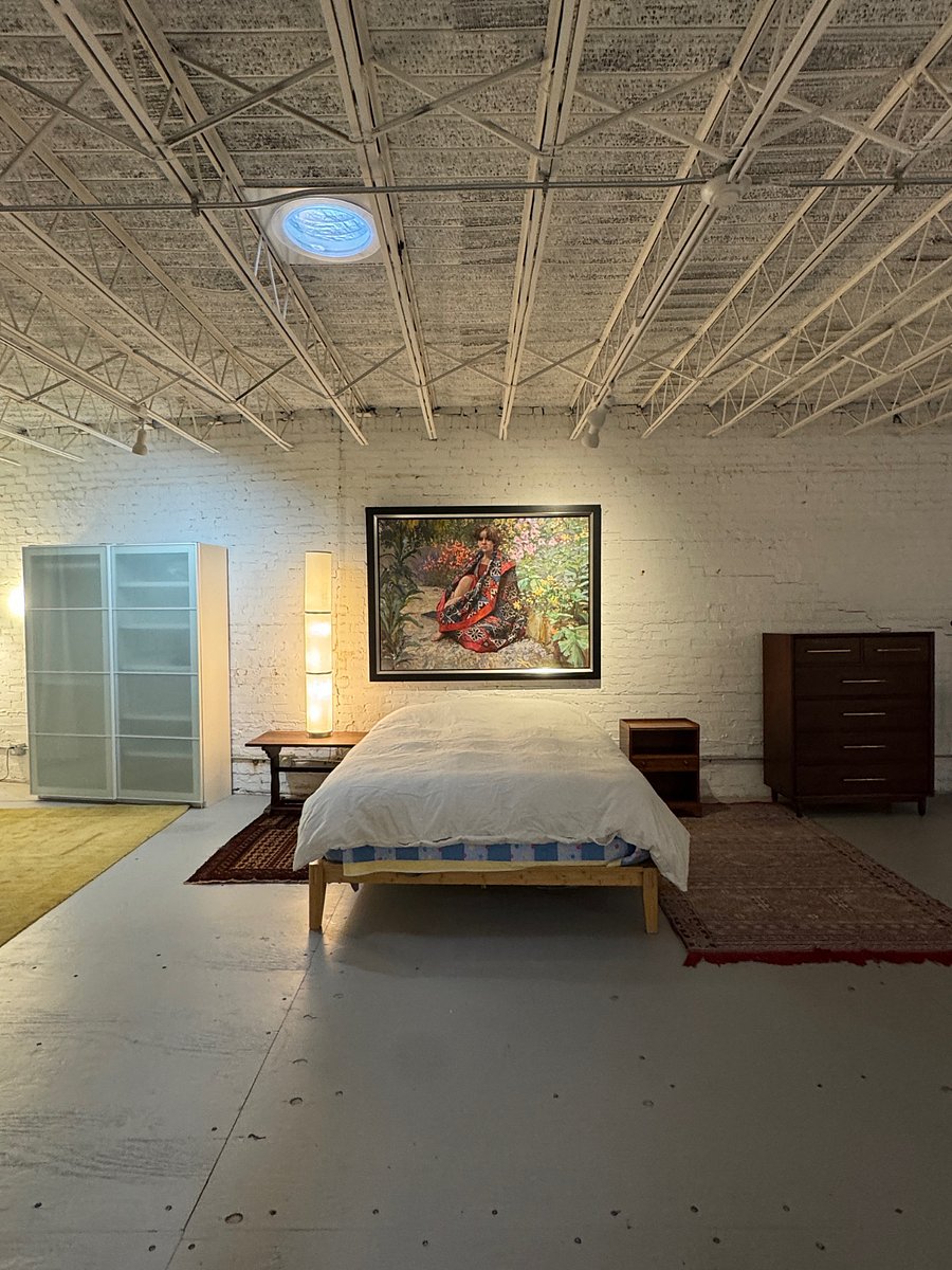 Main sleeping area with one mounted and one freestanding storage for clothes.