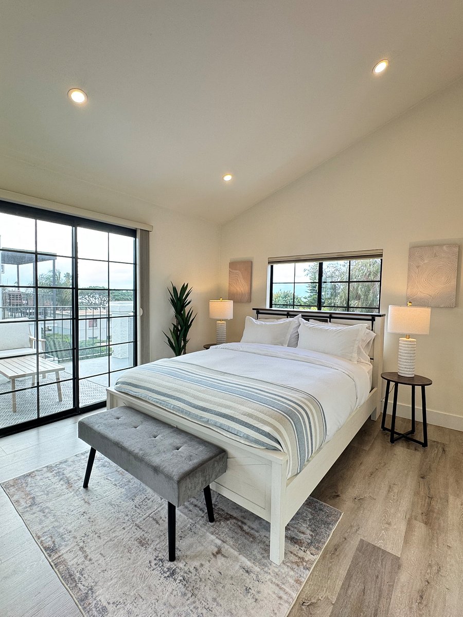 Spare bedroom has balcony access, over-sized closets, top-down, bottom-up premium blackout shades. Queen bed with storage and charging ports in the headboard