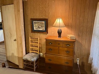 The master bedroom has a full sized dresses for clothing stoage with lamp.
