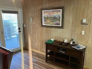 The front door, entrance cabinet and hallway directly to the kitchen and living room.
