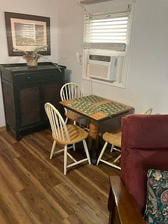 The dining room includes a pie safe for extra kitchen storage and is near the living room with fireplace.