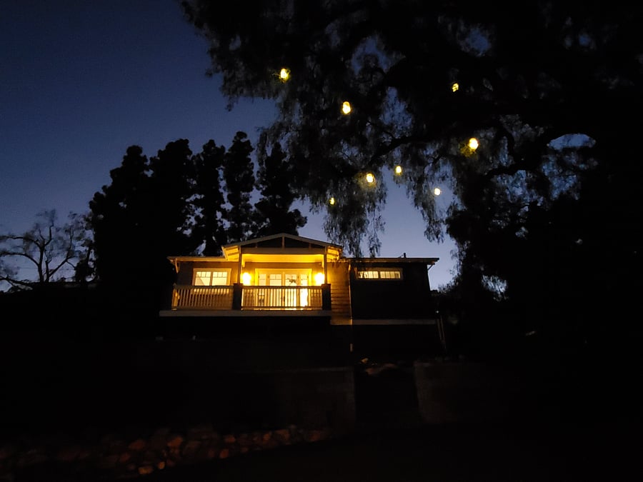 Back of Cottage at night w/ lit pepper tree