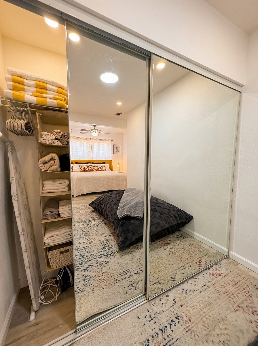 Bedroom closet with organized storage and extra linens