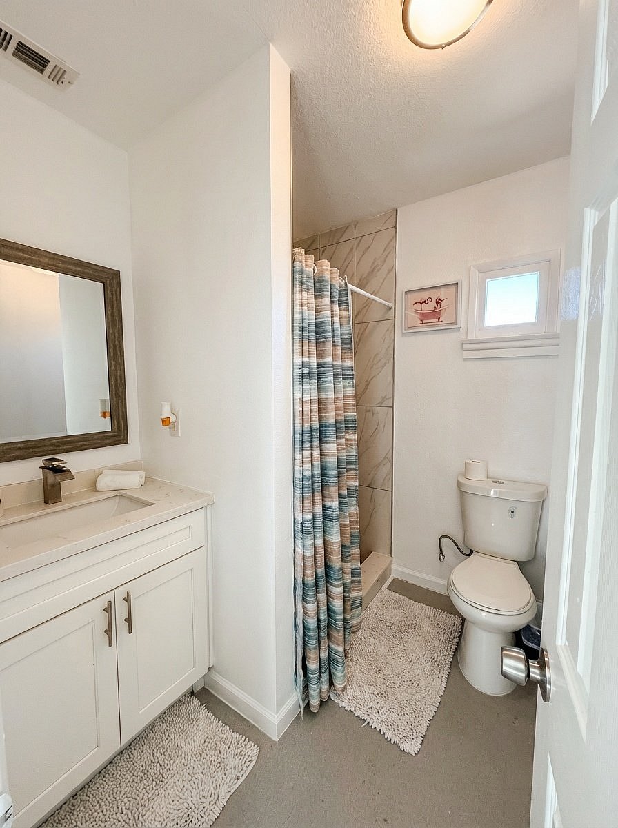 Updated bathroom with shower tub and vanity storage