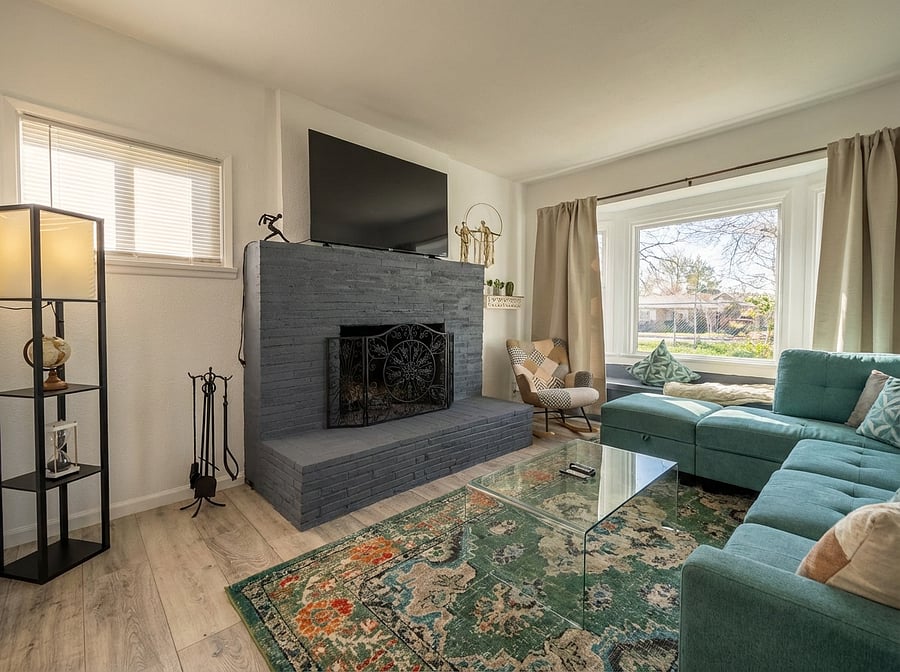 Relaxing seating area with wood fireplace and large windows