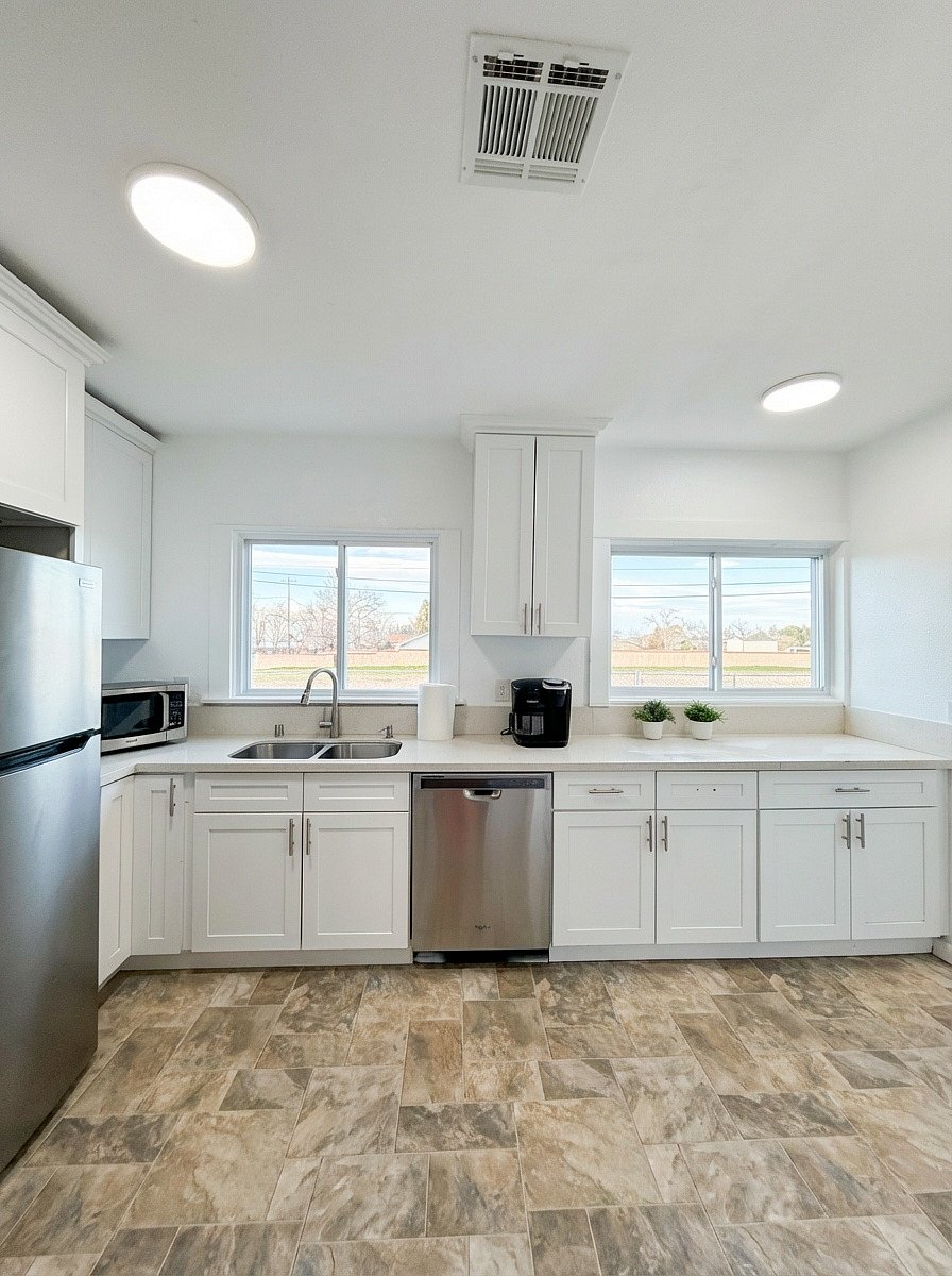Bright modern kitchen with dishwasher and stainless appliances