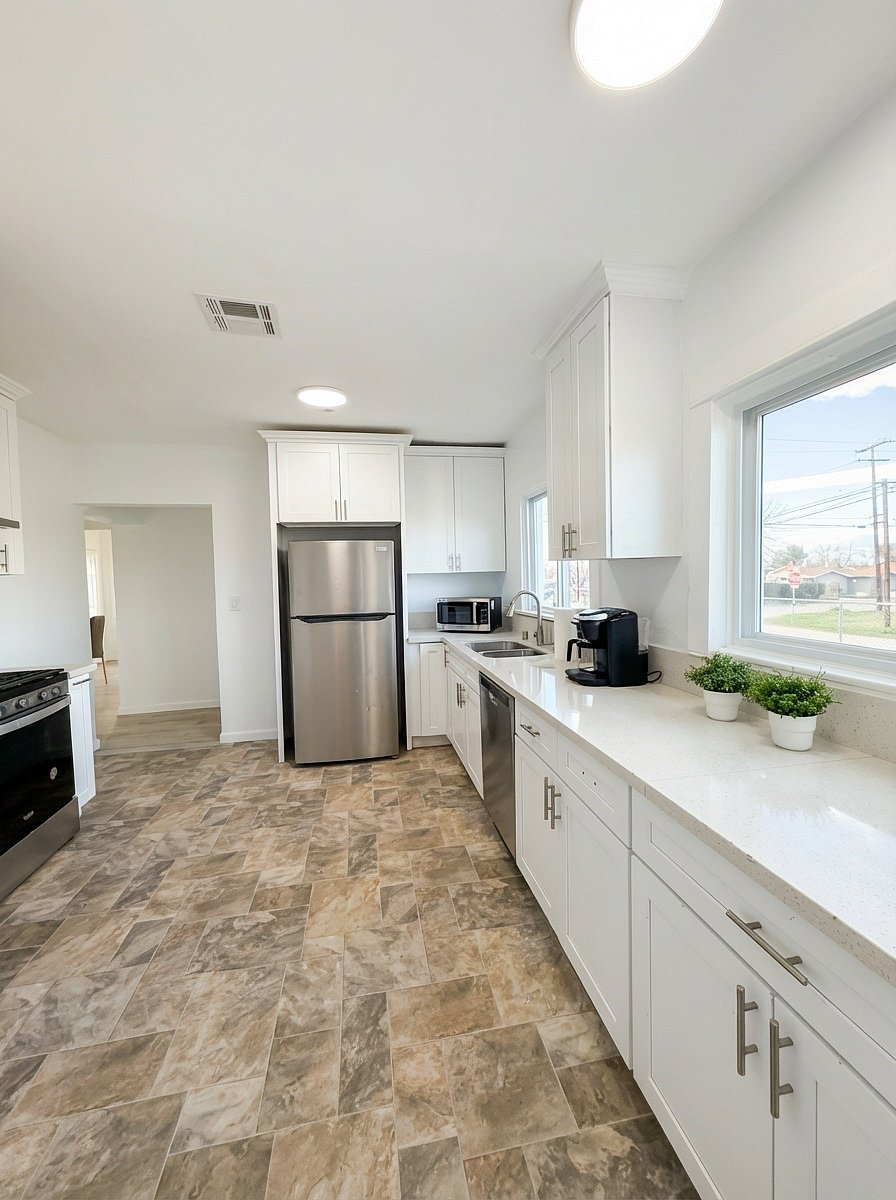 Fully equipped kitchen with stainless fridge and coffee maker