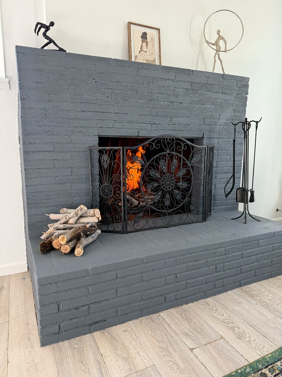 Working wood fireplace with safety screen and cozy lounge setting