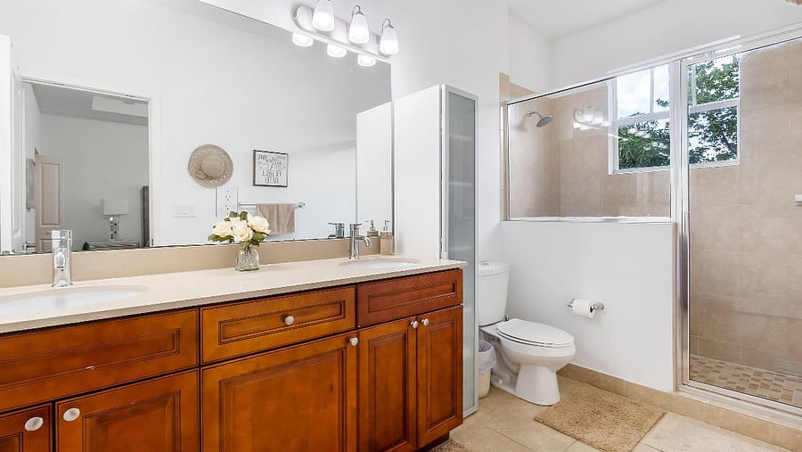Large Ensuite bathroom featuring Double vanity, over-sized shower, and natural light.