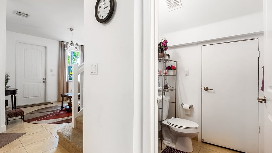Half bathroom separating the kitchen and dining room
