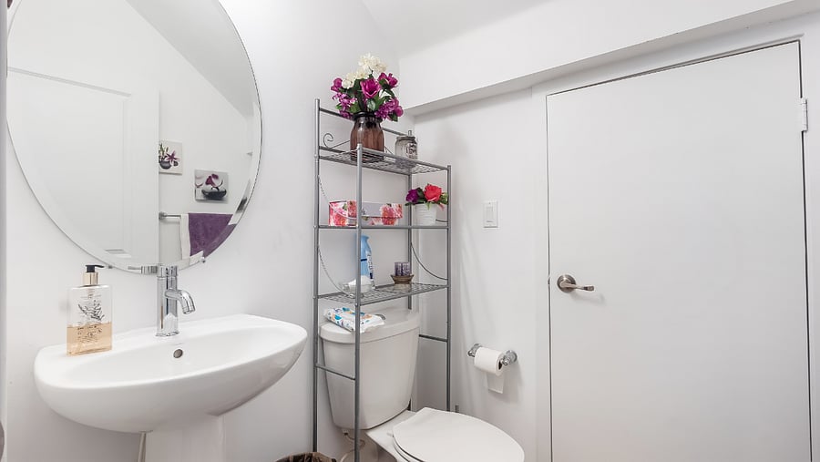 Half bathroom separating the kitchen and dining room