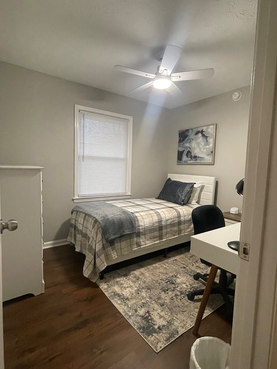 The smaller single guest bedroom is equipped with a desk for work at home, updated lighting and ceiling fan, and white noise machines if you prefer it for sleep.