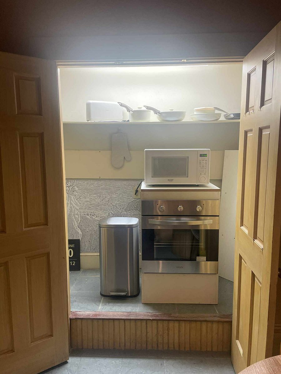 Built-in stove and microwave are in the other closeted kitchen area