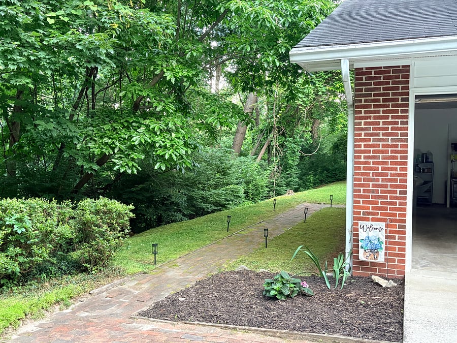 Sidewalk to left of main house/garage