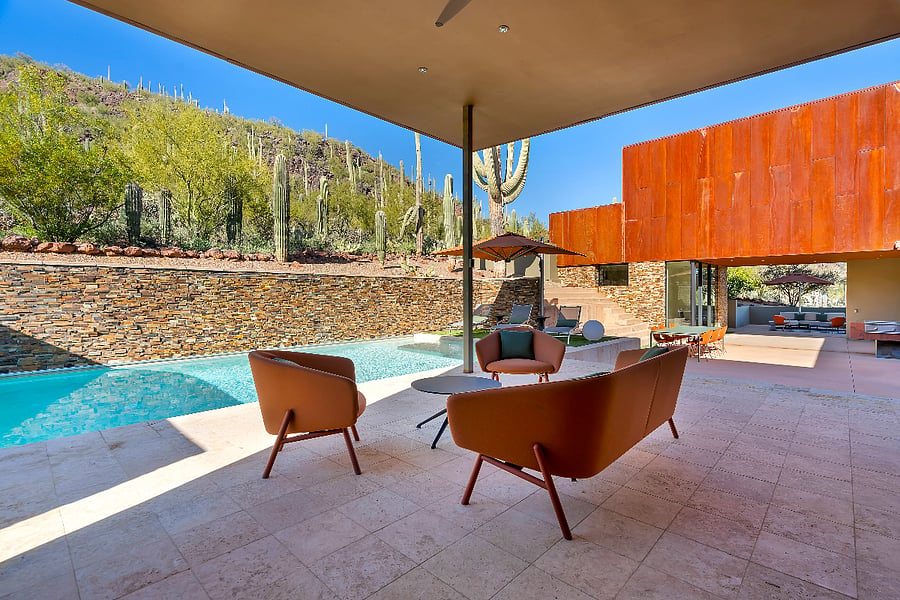 Covered pool terrace with desert views, designed for all-day lounging, swimming, and easy indoor-outdoor living.