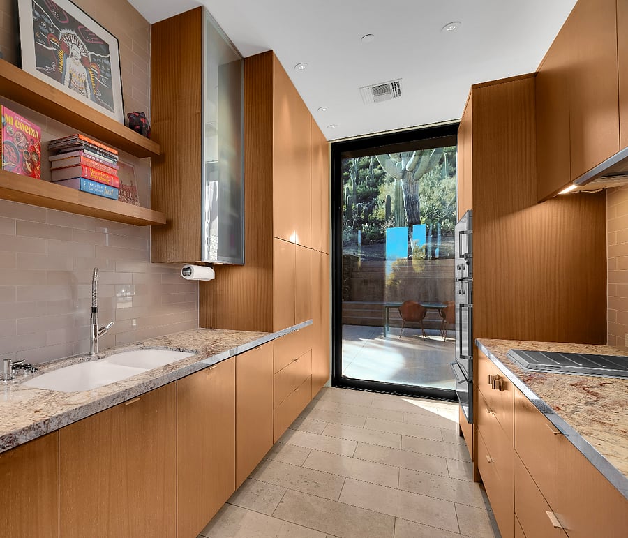Prep kitchen and pantry with additional sink, storage, and appliances.