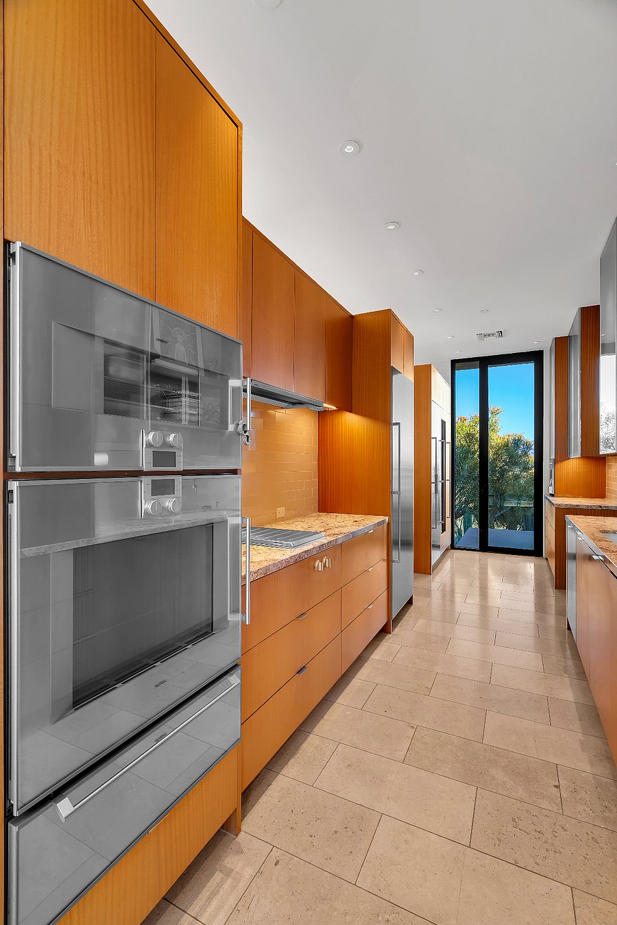Kitchen with double ovens and custom cabinetry throughout.