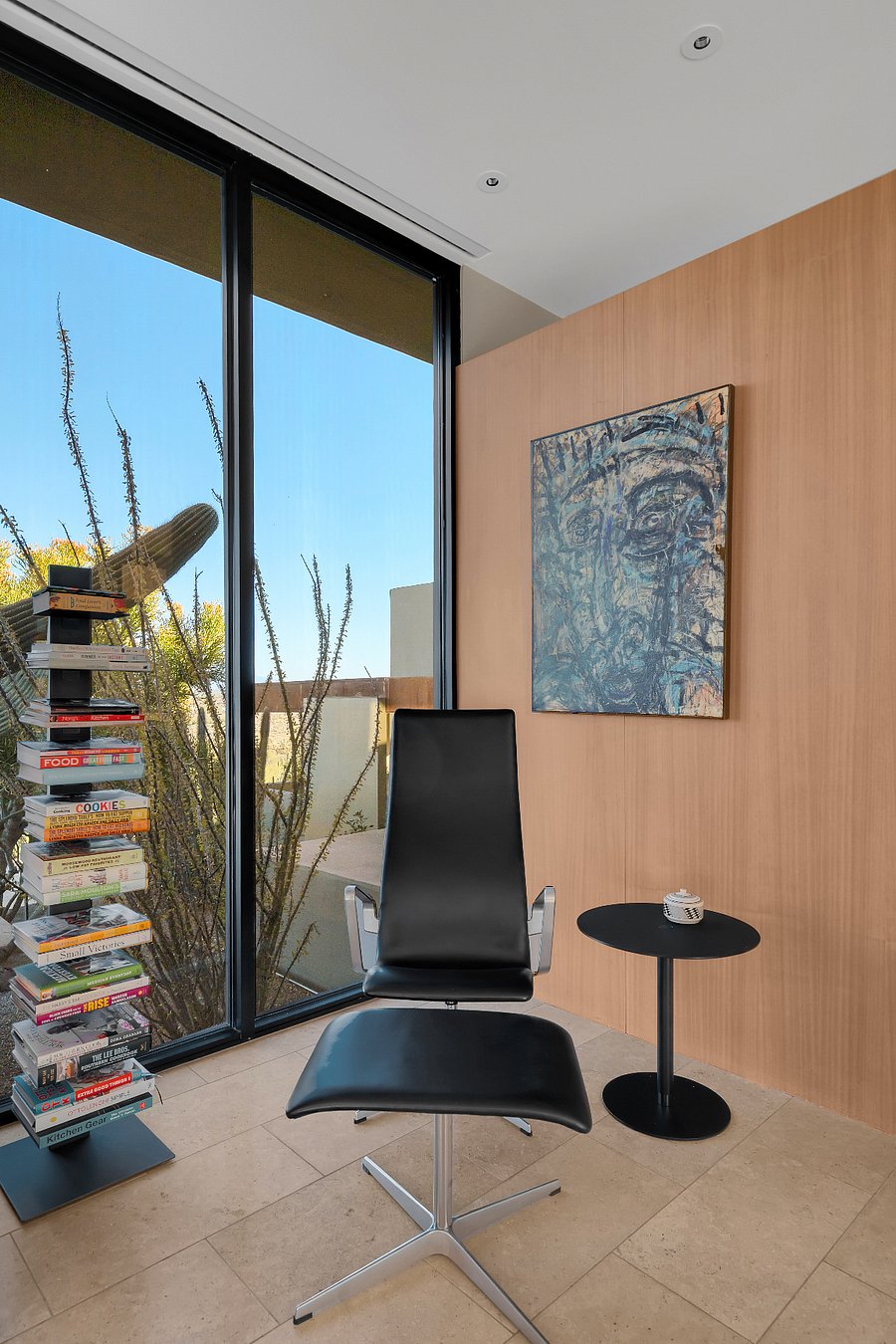 Quiet reading and reflection nook framed by desert light and native cactus.