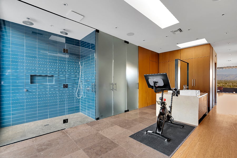 Spa-like primary bath with oversized glass shower, skylights, and open space to unwind.
