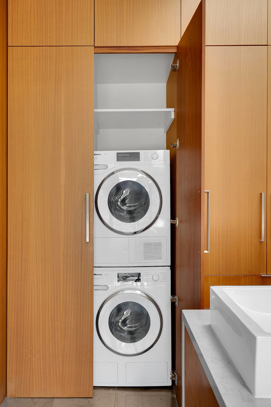 Miele washer and dryer laundry located in the primary bath plus a second set located on the first floor.
