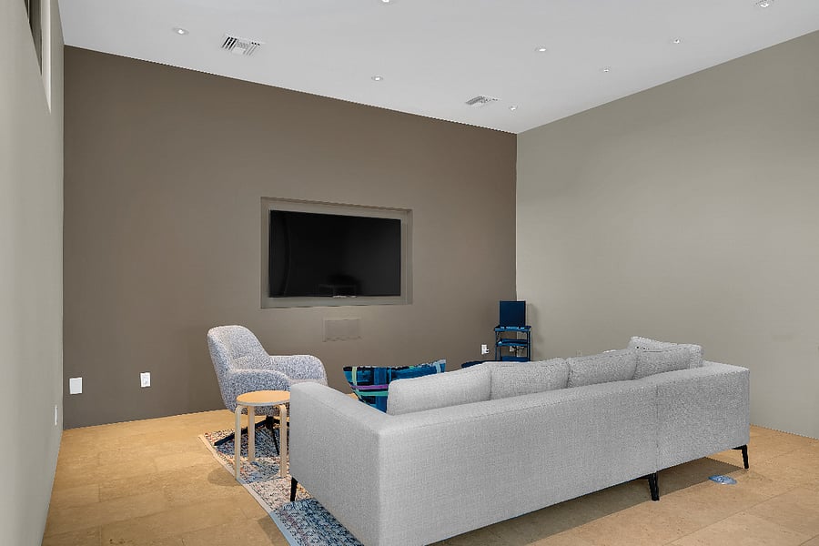 Detached media room with comfortable seating, large screen, and a relaxed space to watch movies or unwind.
