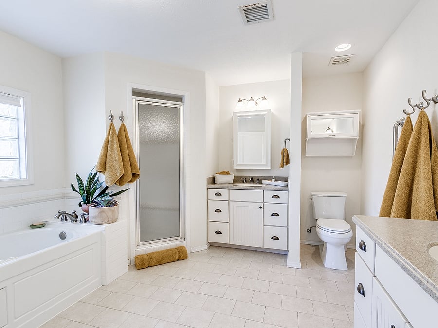 Main bath with jetted tub, shower and two vanities.
