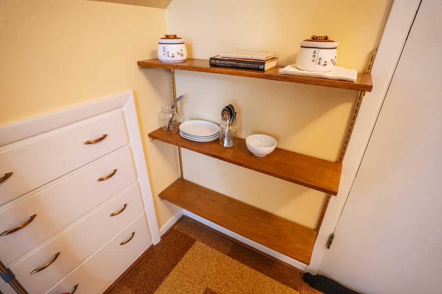 Shelves in east bedroom versus office/kitchenette area.