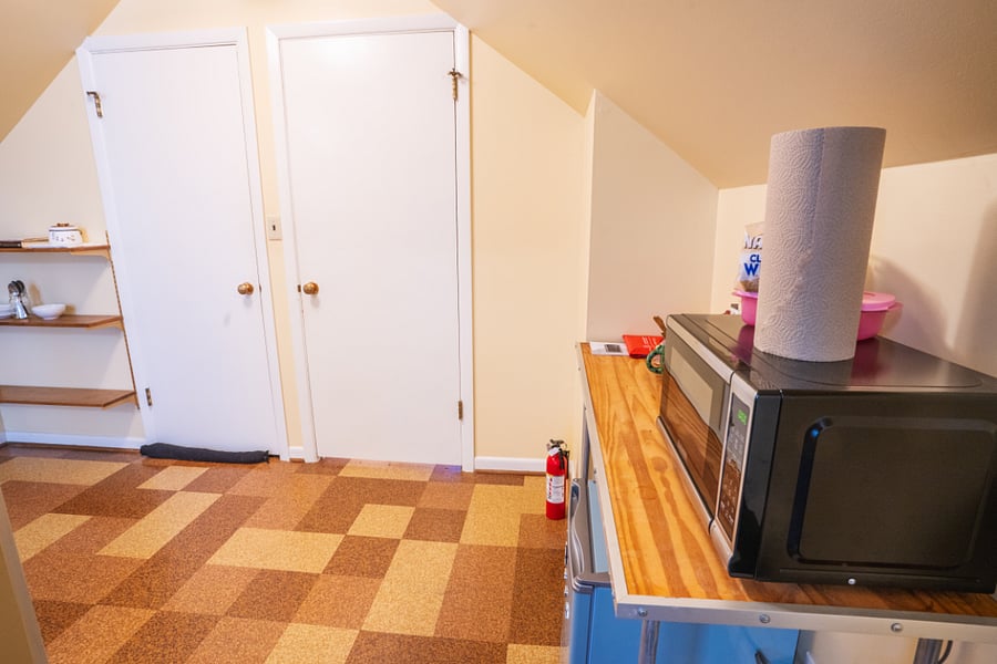 Mini-frig and microwave in east bedroom versus office space.
