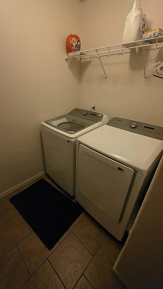 Laundry room with utility sink and large Samsung washer/dryer
