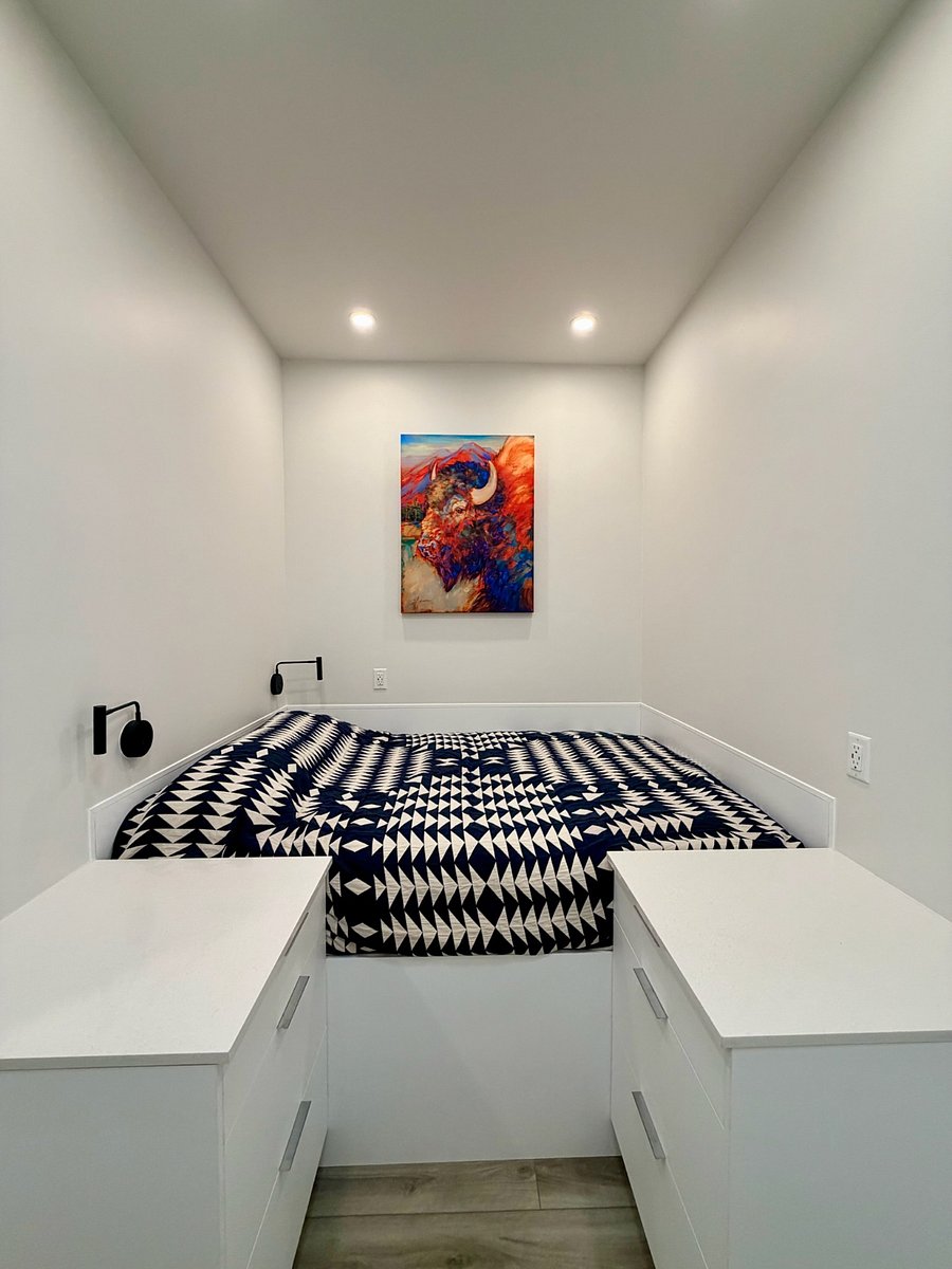 Queen bed with Pendelton comforter, blackout blinds for restorative sleep